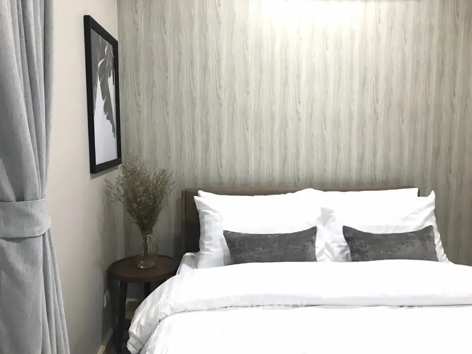 Cozy bedroom with elegant decor and soft lighting, featuring a comfortable bed and stylish wall art.