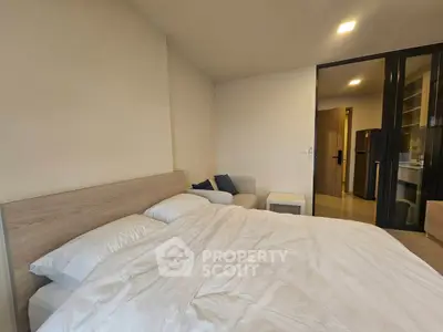 Modern bedroom with cozy bed and stylish decor in a contemporary apartment.