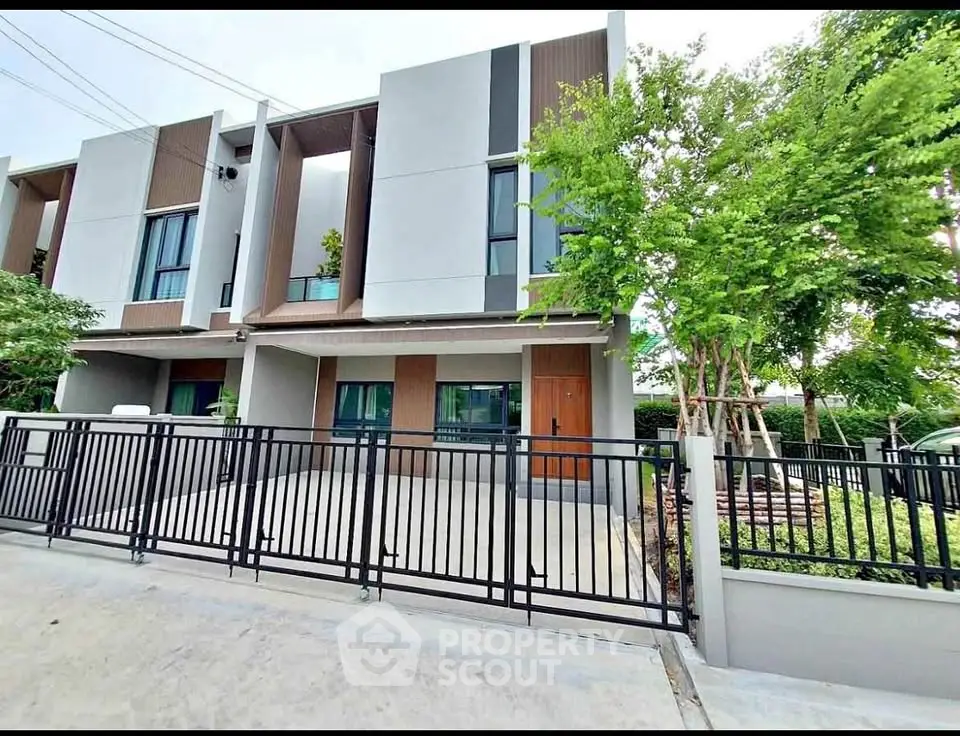 Modern townhouse exterior with sleek design and gated entrance