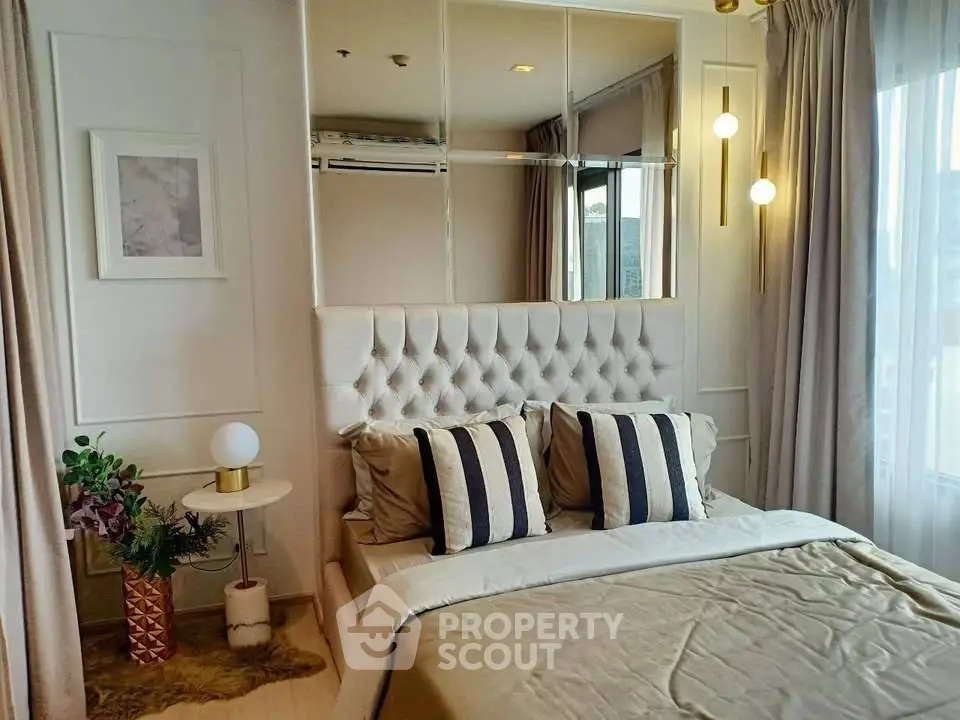 Luxurious bedroom with elegant decor and plush bedding in a modern apartment.
