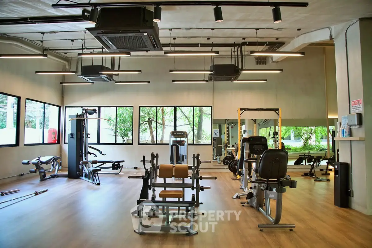 Spacious modern gym with large windows and state-of-the-art equipment