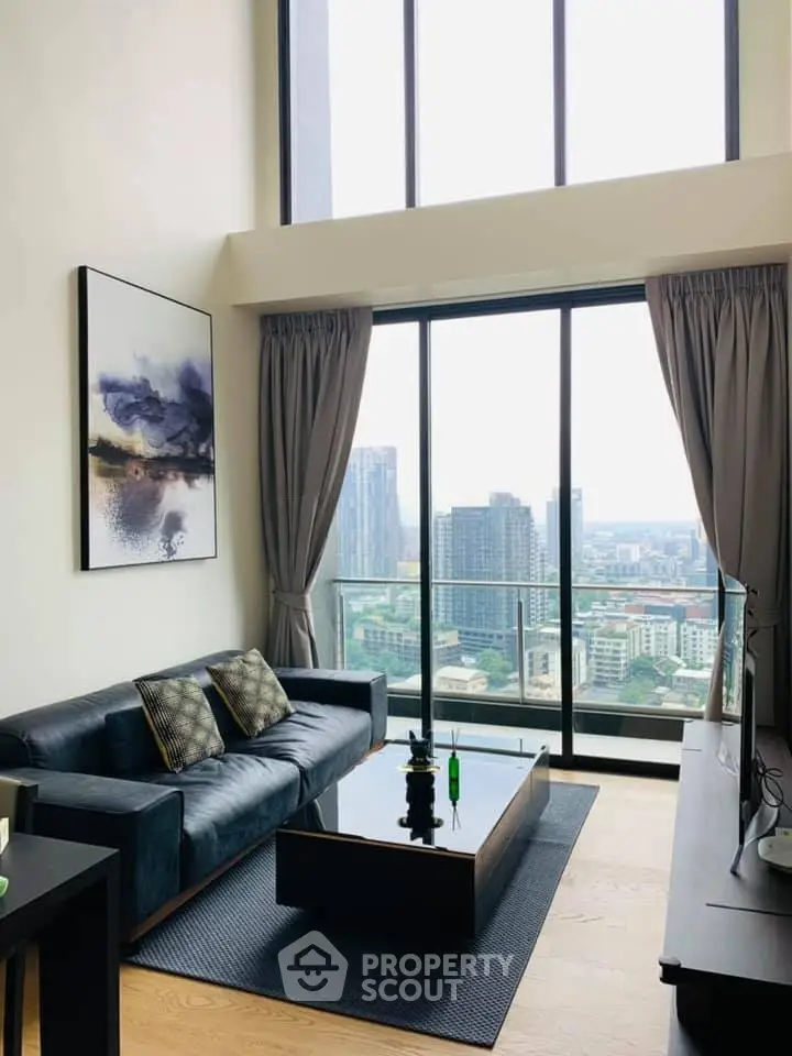 Luxurious high-rise living room with floor-to-ceiling windows and stunning city view.