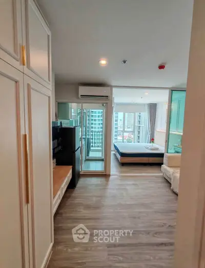 Modern apartment interior with spacious bedroom and balcony view