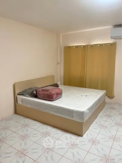 Spacious bedroom with modern bed and air conditioning, perfect for comfortable living.