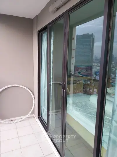 Modern balcony with sliding glass doors and city view