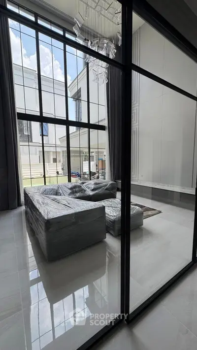 Luxurious modern living room with floor-to-ceiling windows and elegant furniture