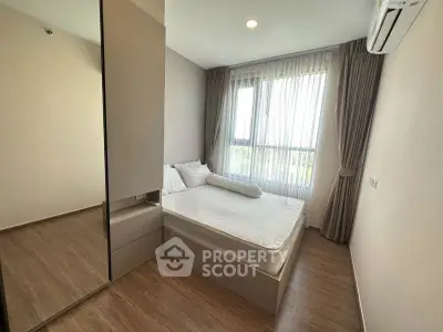 Modern bedroom with large window and minimalist design in a stylish apartment.