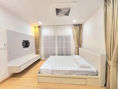 Spacious modern bedroom with elegant curtains and minimalist design