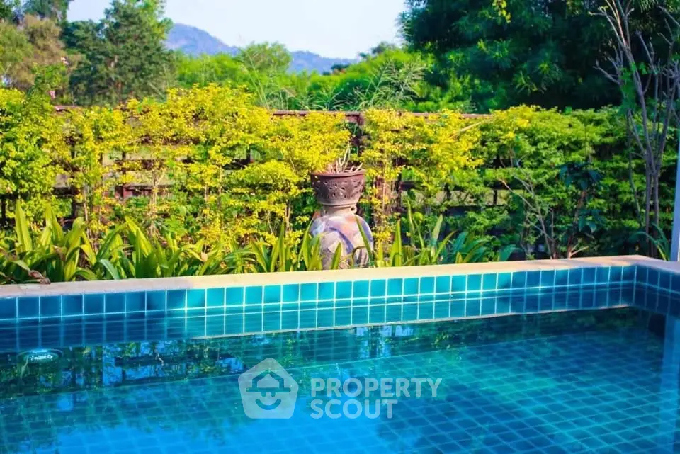 Luxurious private pool surrounded by lush greenery and scenic views.