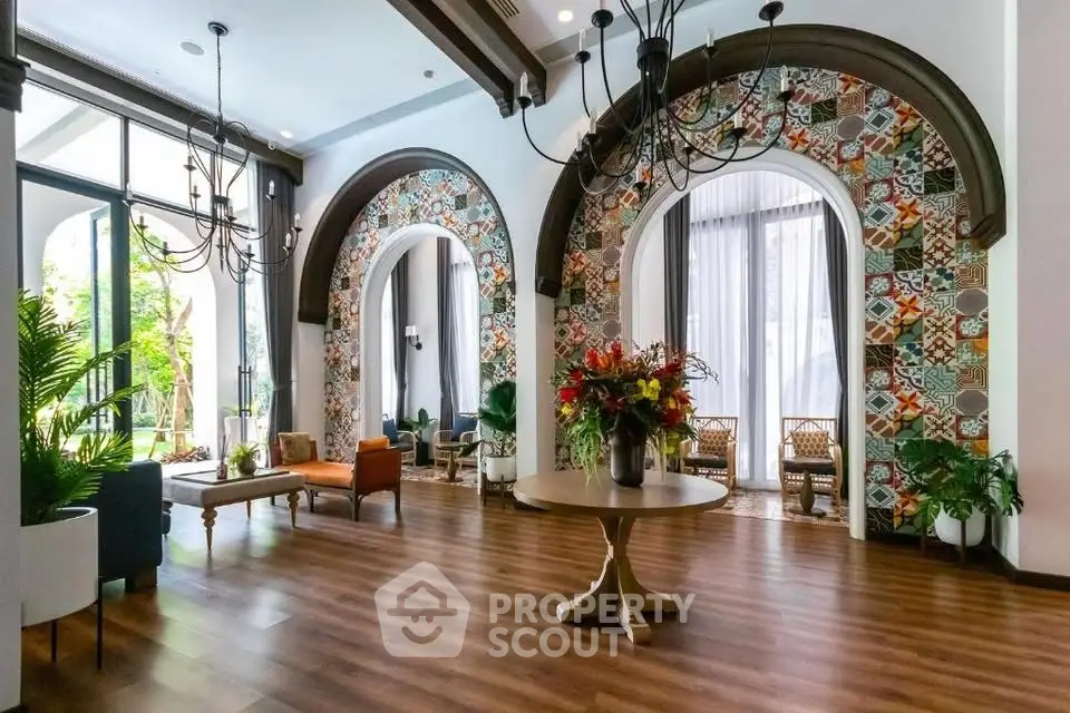 Elegant living room with arched windows and vibrant decor in luxury home