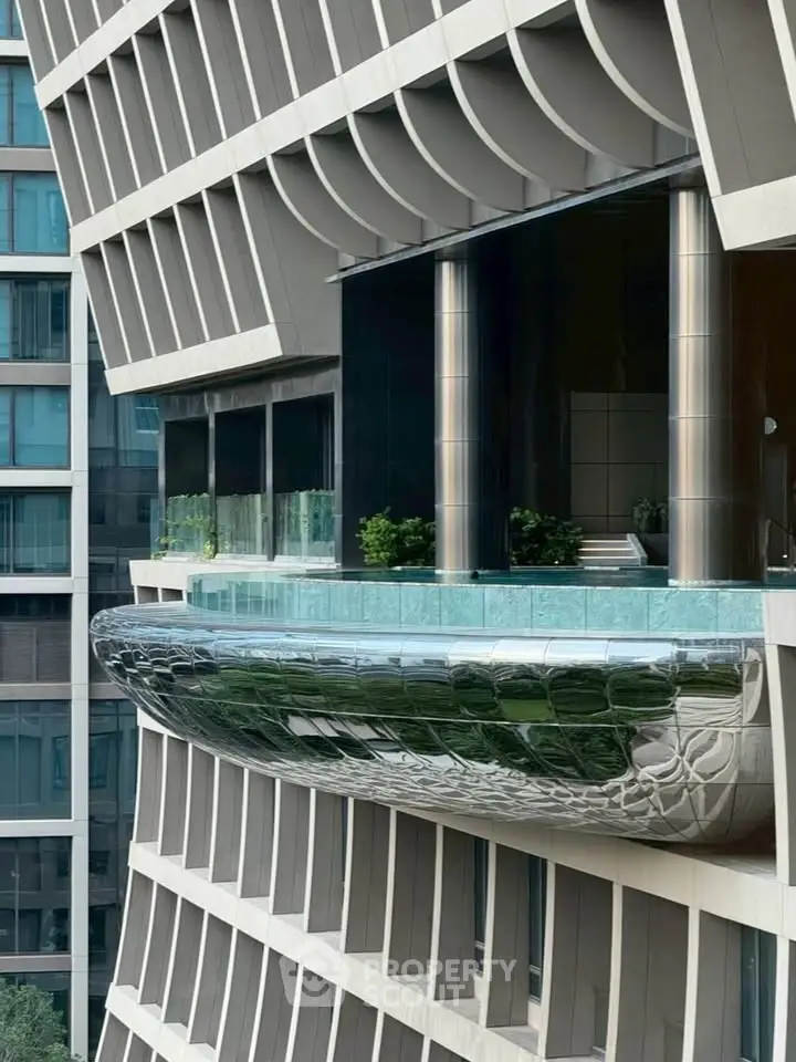 Stunning modern building exterior with unique architectural design and sleek balcony.
