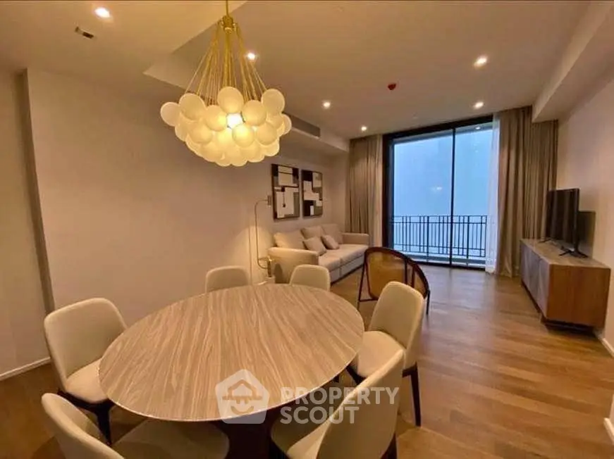 Modern living room with elegant dining area and balcony view