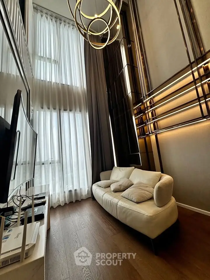 Luxurious high-ceiling living room with modern lighting and elegant decor