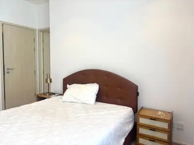 Cozy bedroom with modern furnishings and neutral tones, perfect for relaxation and comfort.