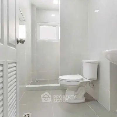 Modern minimalist bathroom with sleek fixtures and neutral tones.