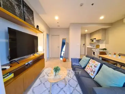 Modern living room with cozy seating and open kitchen layout, perfect for urban living.