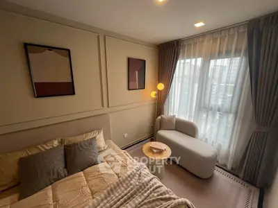 Elegant bedroom with modern decor and large window view