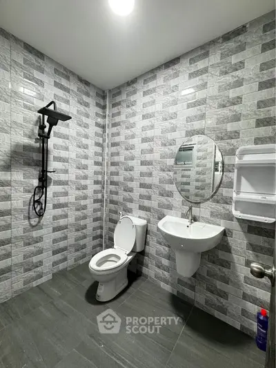 Modern bathroom with sleek gray tiles and contemporary fixtures