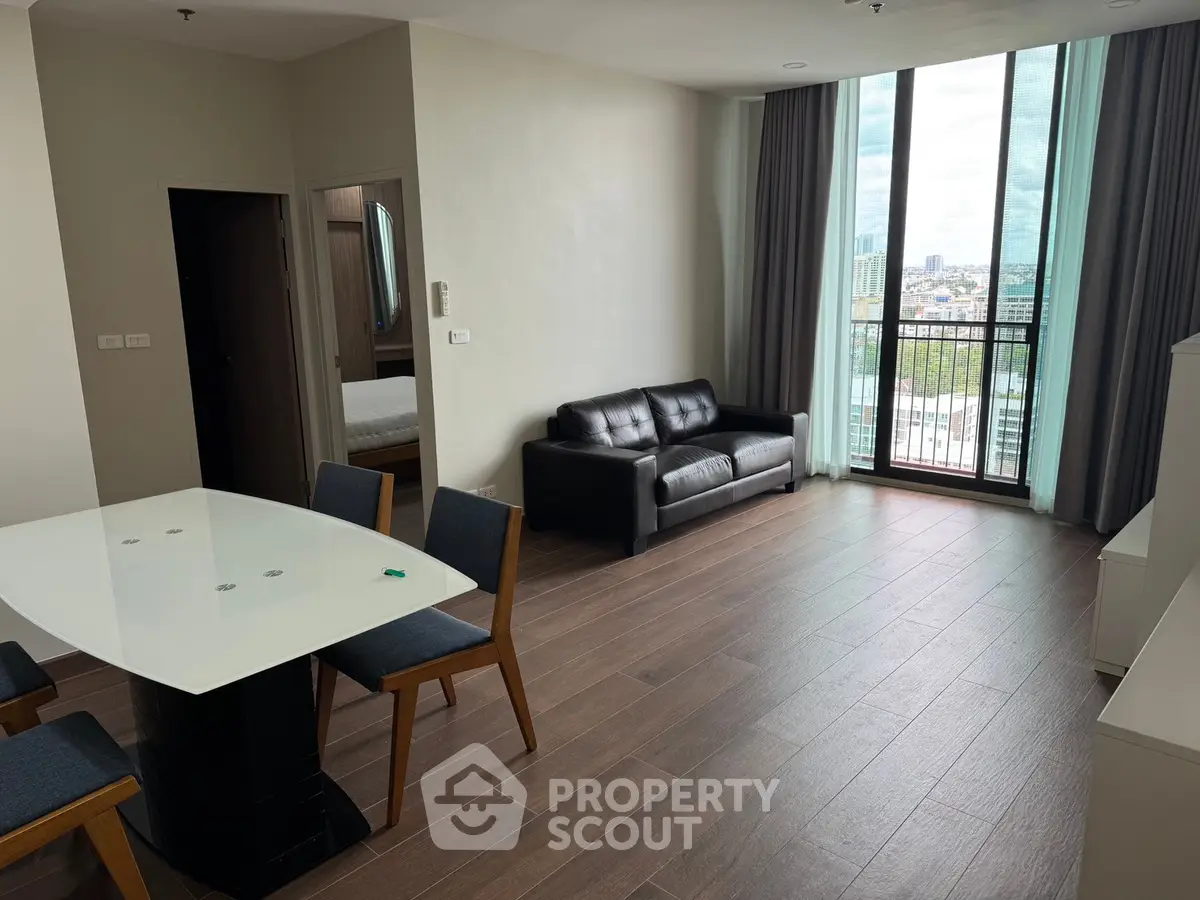 Spacious modern living room with large windows and city view