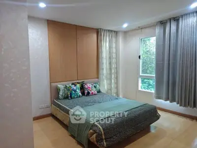 Cozy bedroom with large window and stylish decor in modern apartment