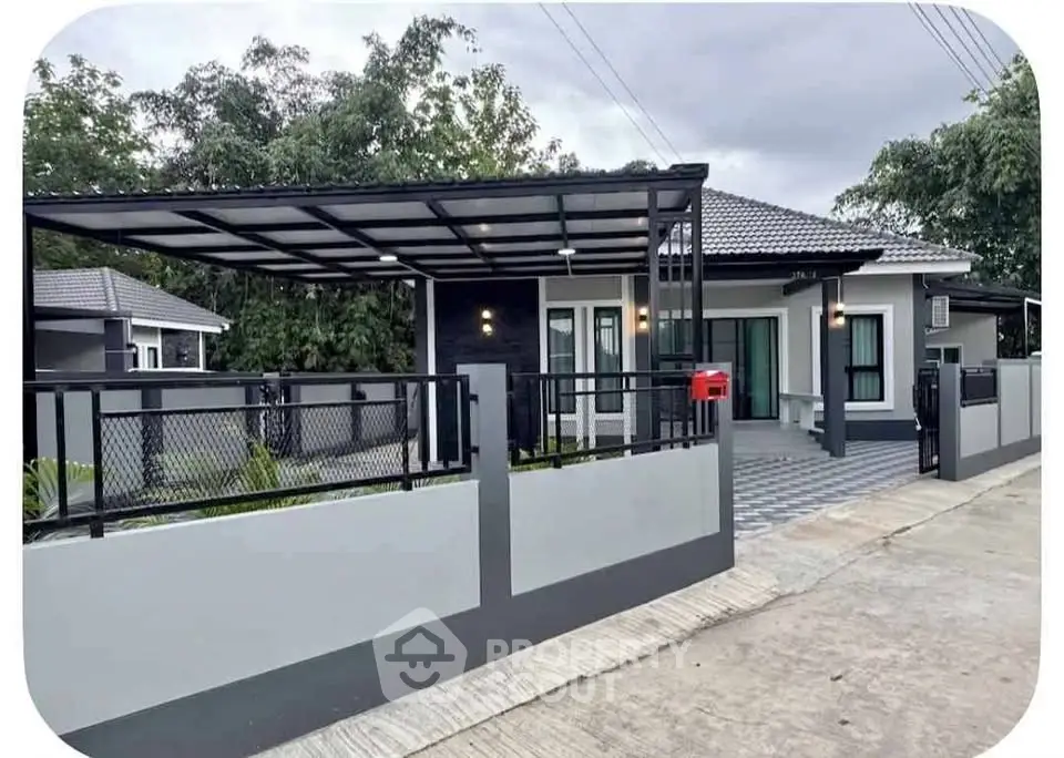 Modern single-story house with sleek design and spacious driveway in a serene neighborhood.