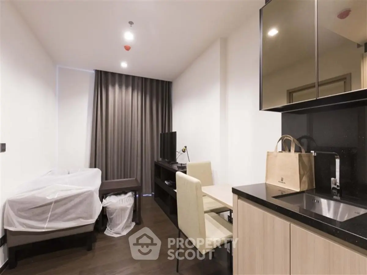 Modern studio apartment with sleek kitchen and cozy living area