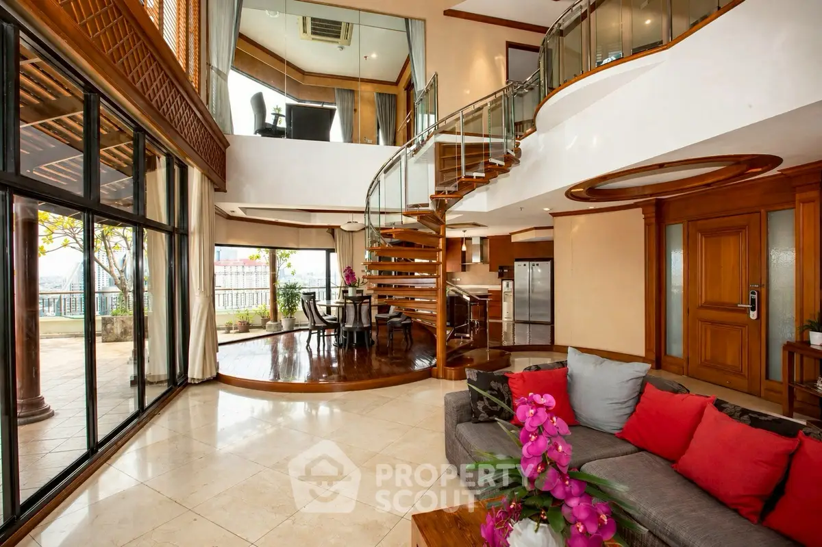 Luxurious open-plan living room with spiral staircase and modern decor, perfect for upscale living.