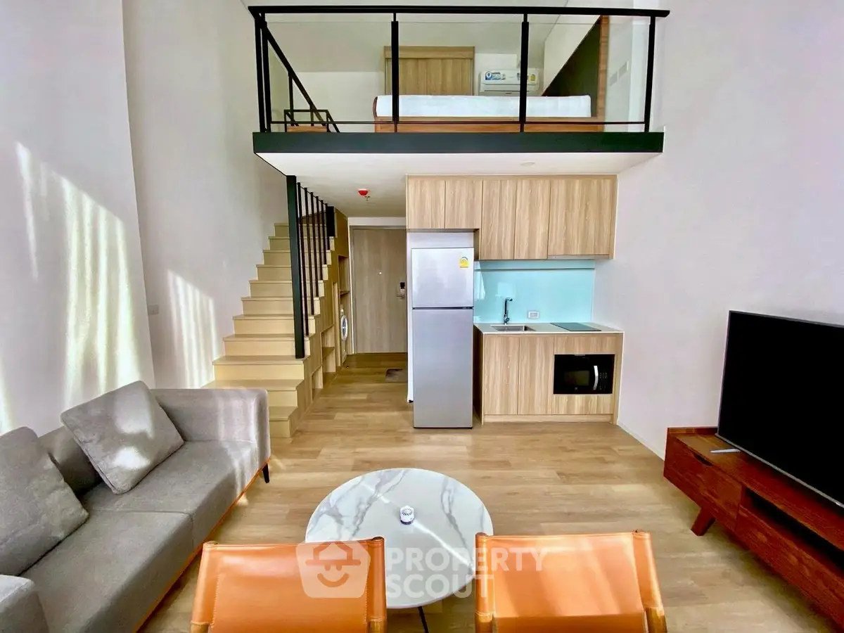 Modern loft apartment with stylish living area and compact kitchen