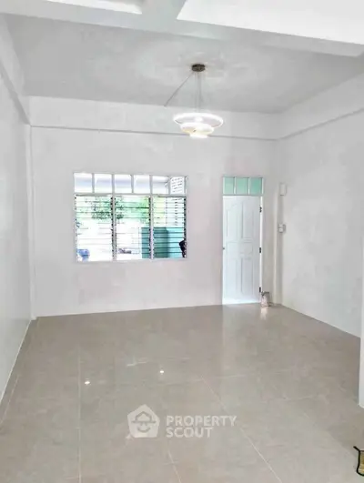 Spacious and bright living room with modern lighting and large window