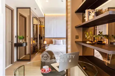 Modern bedroom with stylish decor, glass desk, and elegant shelving in a cozy apartment.