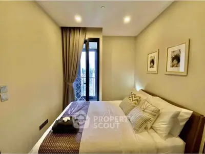 Cozy bedroom with elegant decor and natural light from balcony view.