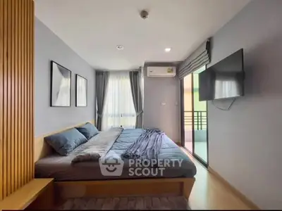 Modern bedroom with balcony access and stylish decor in a cozy apartment.