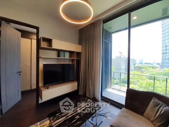 Modern living room with large balcony and city view, featuring sleek furniture and stylish lighting.