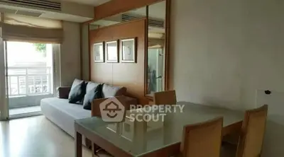 Spacious living room with modern furniture and large window for natural light.