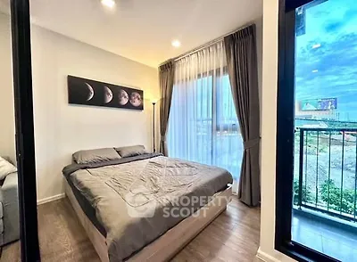 Modern bedroom with large window and balcony view, featuring stylish decor and cozy ambiance.