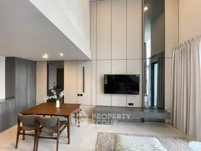 Modern living room with high ceiling and sleek furniture design