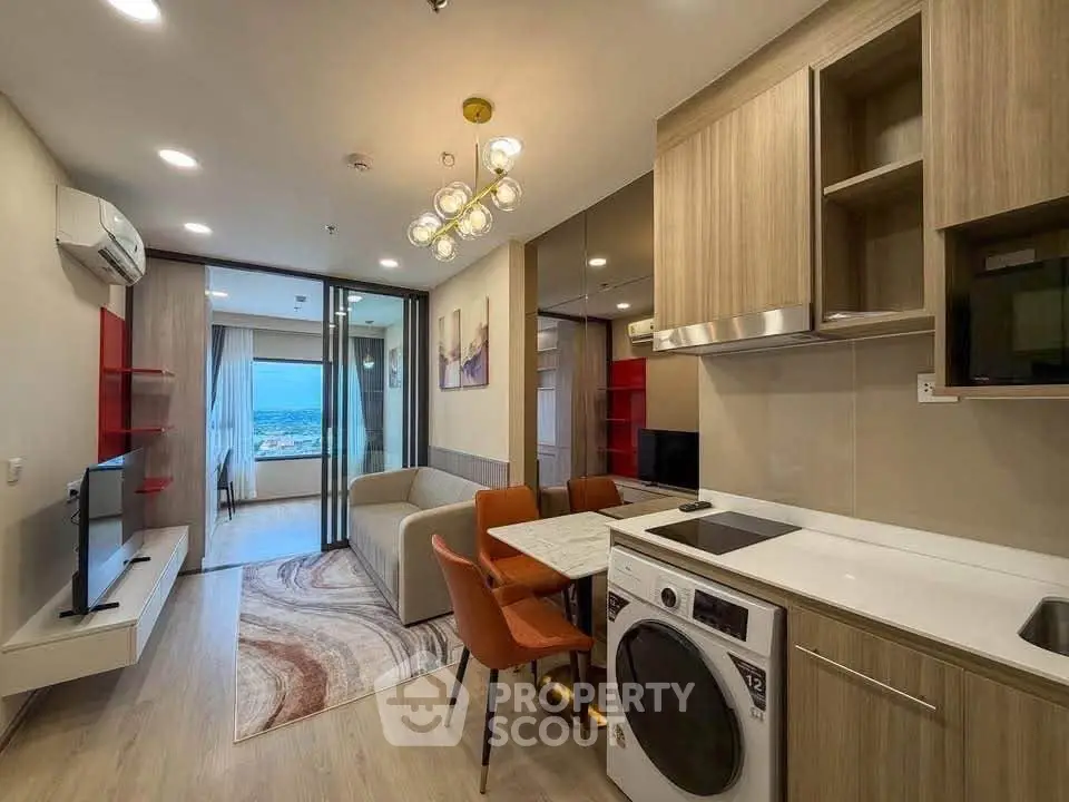 Modern open-layout living room with kitchen, featuring stylish furniture and a scenic view.