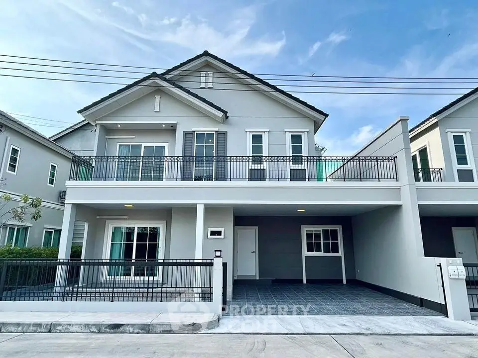 Elegant two-story house with spacious balcony and modern exterior design