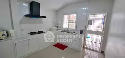 Modern kitchen with sleek white cabinets and gas stove in a bright, airy space.