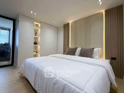 Luxurious bedroom with modern design and ambient lighting, featuring a plush bed and stylish decor.