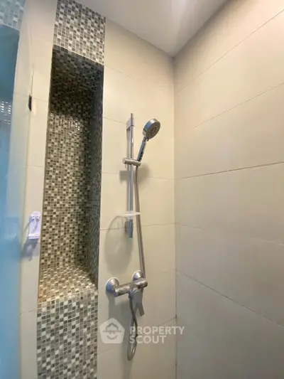 Modern bathroom shower with sleek tile design and built-in niche