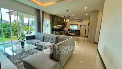 Spacious modern living room with open kitchen and garden view