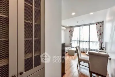 Spacious living room with elegant furniture and large window for natural light.