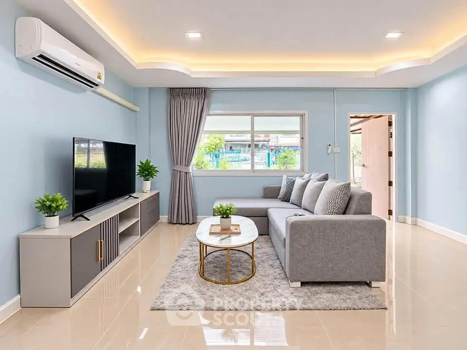 Modern living room with sleek design, featuring a cozy gray sofa, stylish TV unit, and elegant lighting.