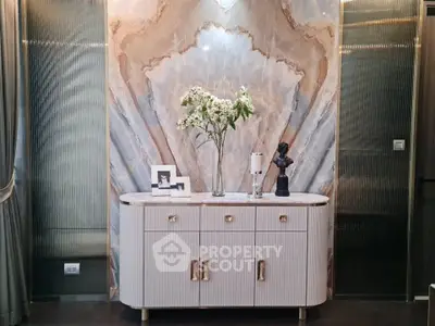 Luxurious interior with elegant sideboard and marble accent wall, perfect for sophisticated living spaces.