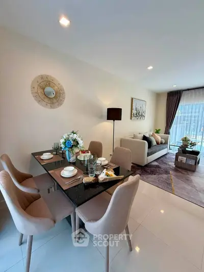 Elegant open-plan living and dining area with modern decor and natural light.