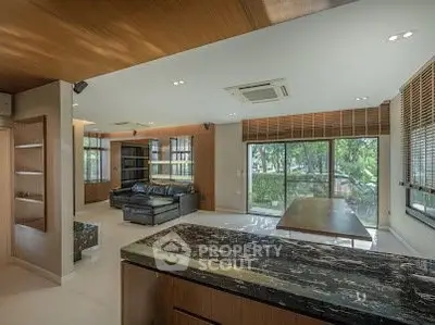 Spacious modern living room with large windows and garden view