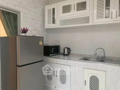 Modern kitchen with sleek appliances and stylish cabinetry in a contemporary home.