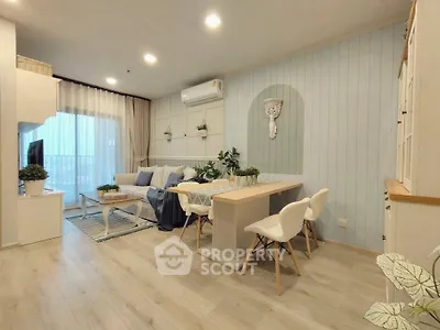 Charming open-plan living and dining area with modern decor and natural light.
