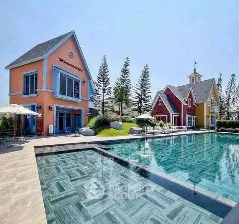 Stunning residential property with vibrant houses and luxurious poolside view.